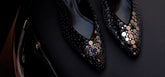 Black studded high heels on a dark background