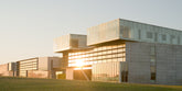 Modern building with glass facade at sunset